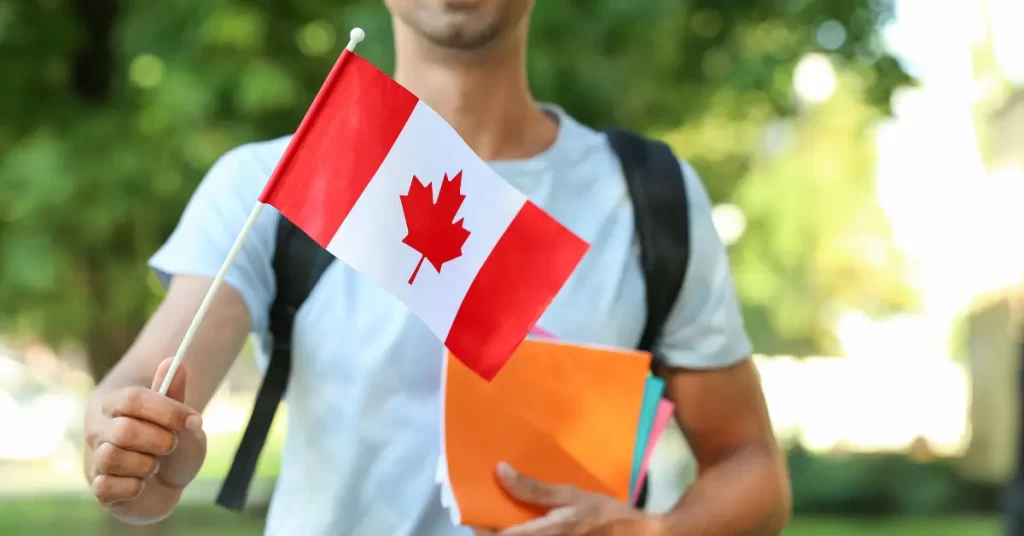 college student holding canada flag