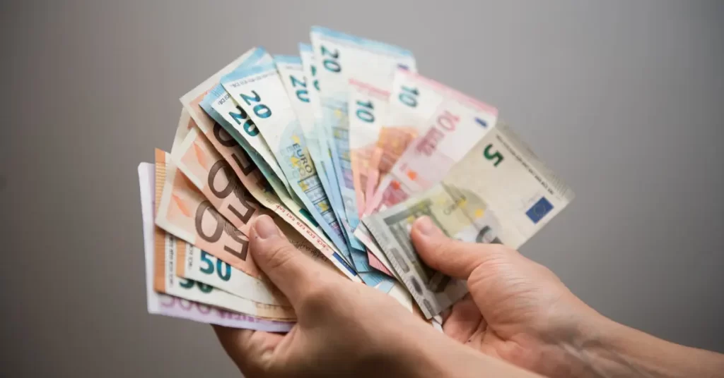 female hand holding euro banknotes