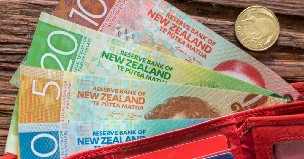 newzealand currency in a red purse