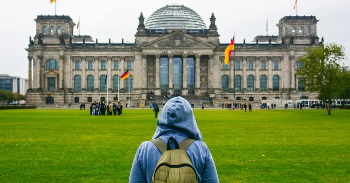 a student facing towards a german university building